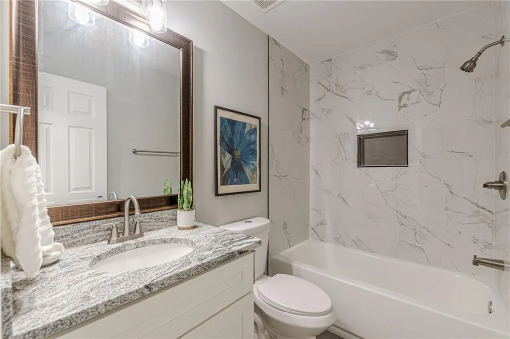 Full bath featuring tub / shower combination and vanity
