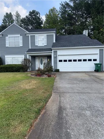Gray siding exterior with white window shutters
