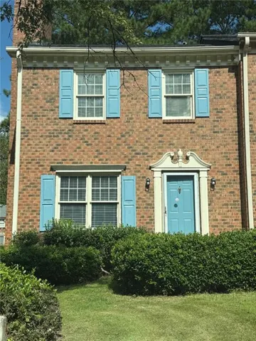 Brick facade with classic blue shutters