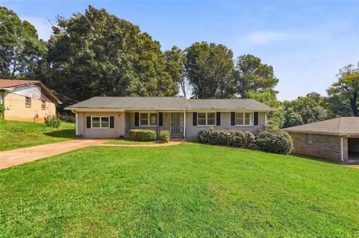 Charming brick ranch home set on expansive manicured grounds with mature landscaping
