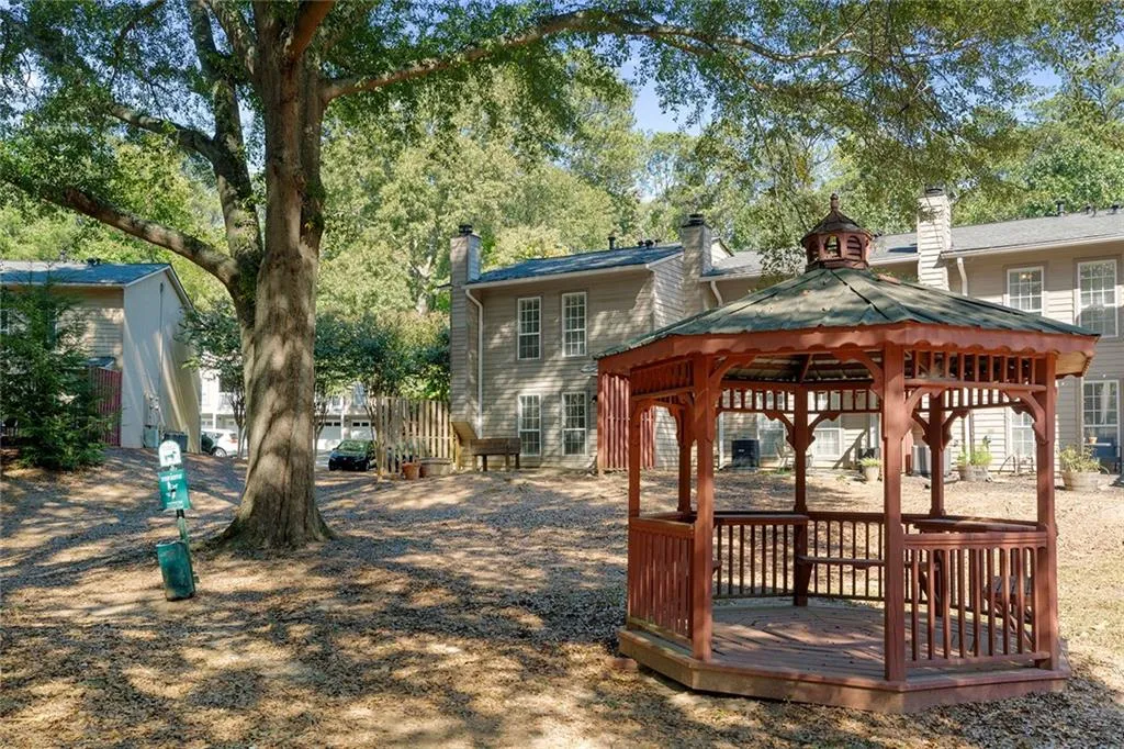 View of home's community featuring a wooden deck and a gazebo