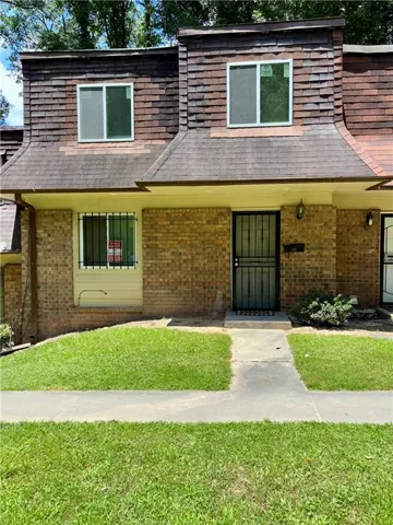 Brick facade exterior featuring a dormer roof and upper-level windows