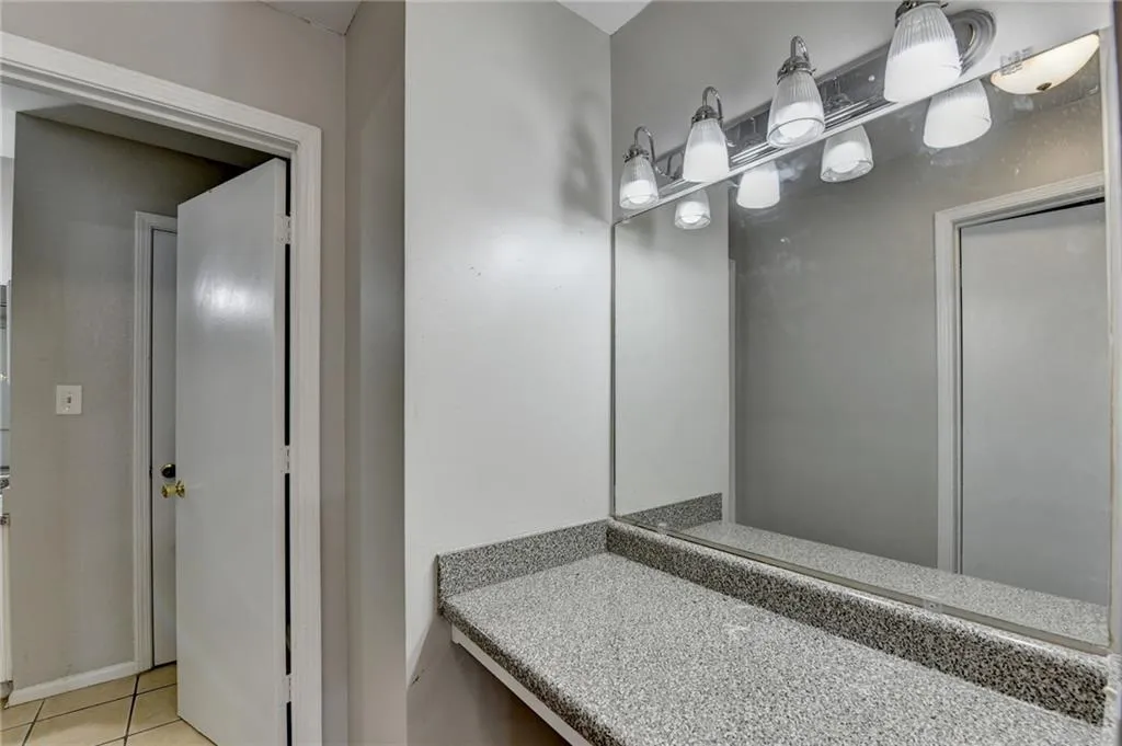 Bathroom featuring light tile patterned floors and vanity