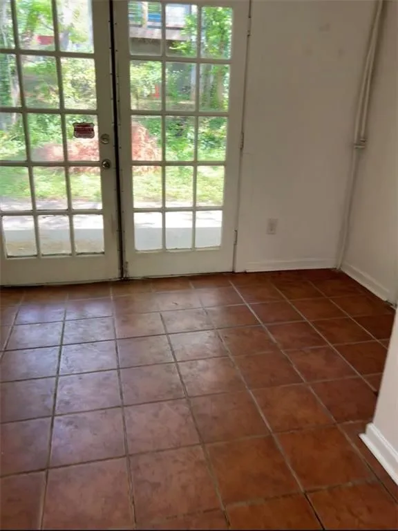 Entryway featuring tile patterned flooring and french doors Entryway featuring tile patterned flooring and french doors