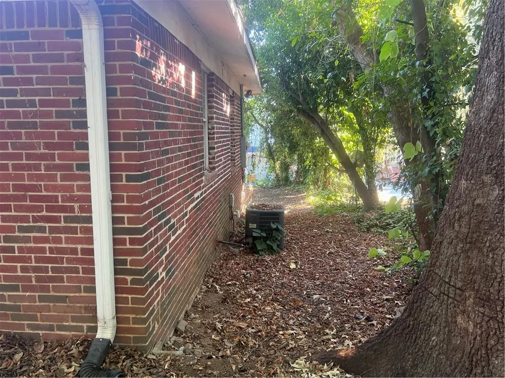 View of property exterior featuring brick siding and a central AC unit View of property exterior featuring brick siding and a central AC unit