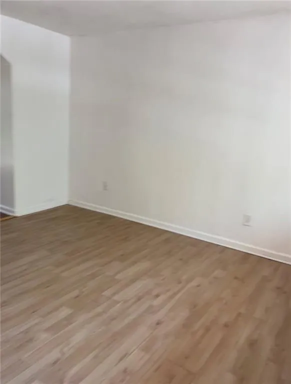 Spare room with wood finished floors Spare room with wood finished floors