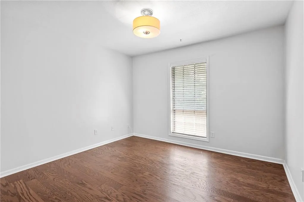 Second bedroom has large picture window and drum lighting.