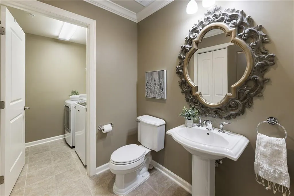 Secondary bathroom with tub and shower plus access to the laundry room.