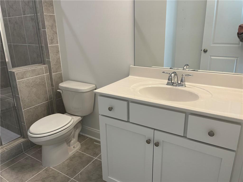 The terrace bath view of vanities and white cabinetry.
