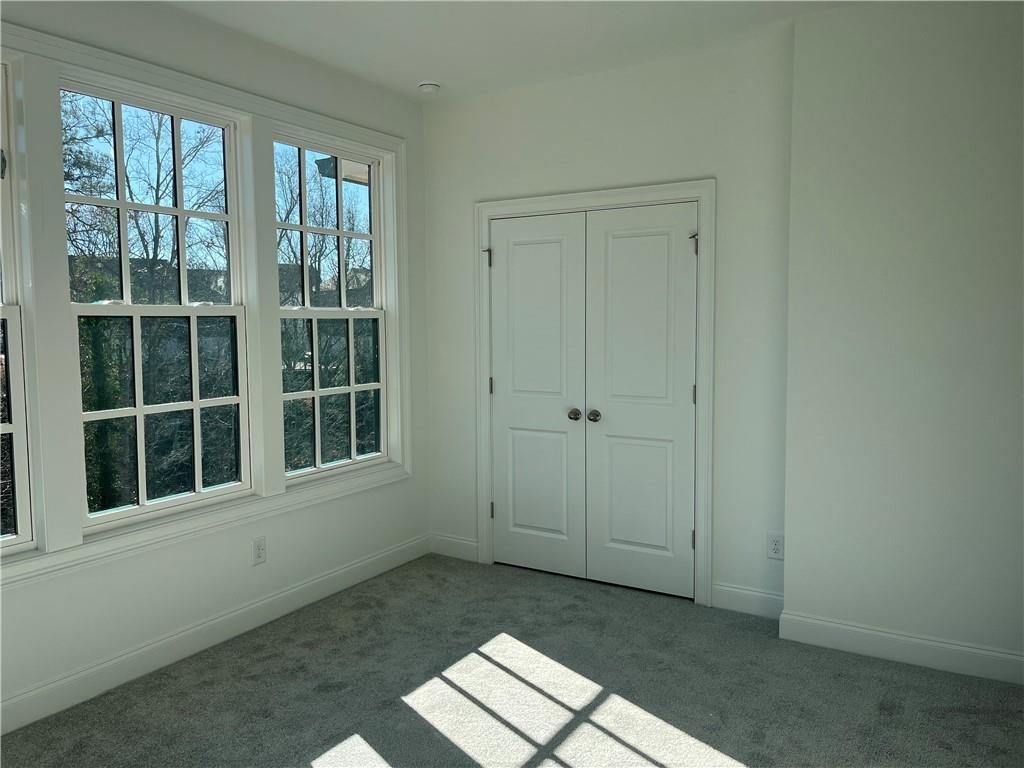 The upstairs secondary bedroom views out over the park.  It has great natural light also!