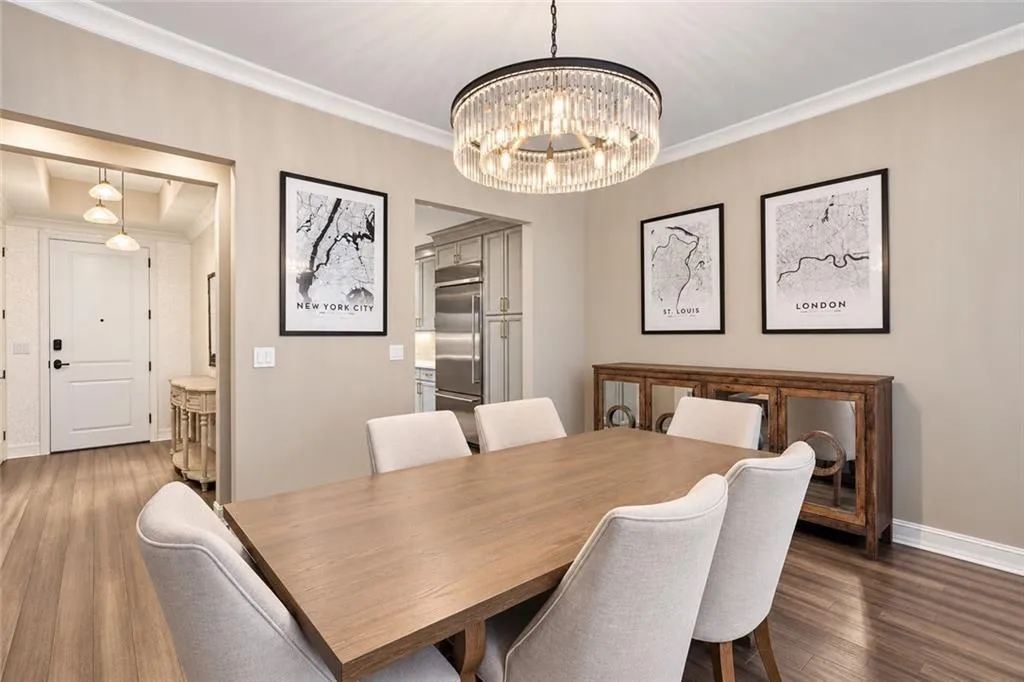 Wood-finish flooring throughout, crown molding, and a crystal chandelier