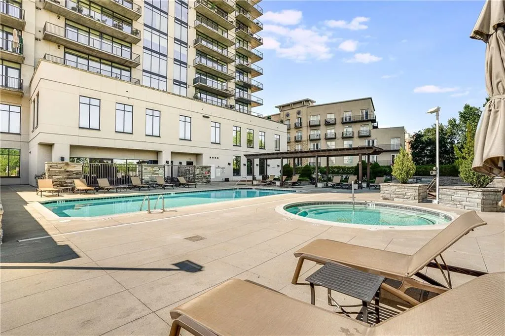 Outdoor pool and spa with concrete decking