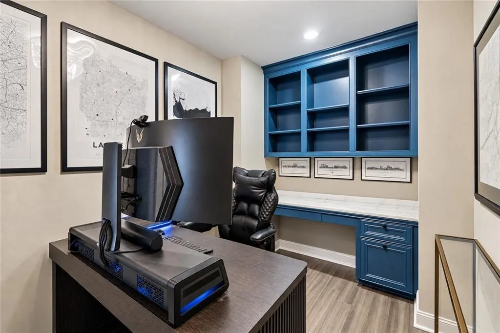 Built-in cabinetry with shelving, desk, and storage, wood-finish flooring, and recessed lighting