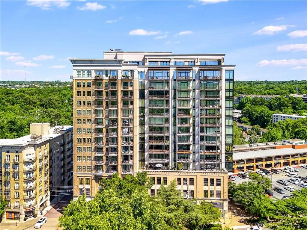 High-rise building featuring a multi-story facade, numerous private balconies, and extensive window lines
