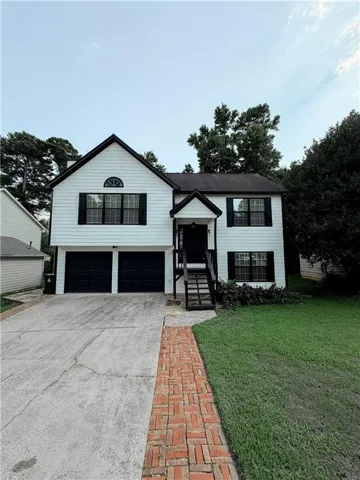 Two-story residence featuring white siding and black trim