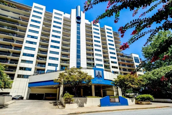 Multi-story high-rise building with a distinctive blue and white facade