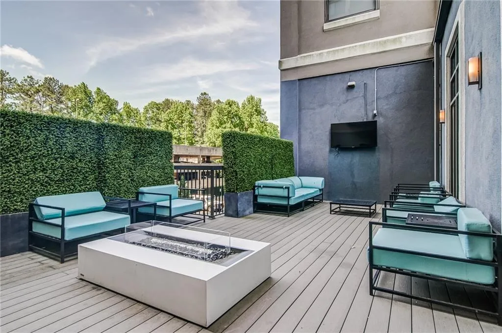 Deck featuring an outdoor living space with a fire pit