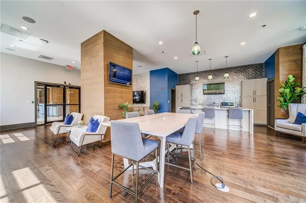 Dining space featuring wood finished floors, recessed lighting, and an accent wall