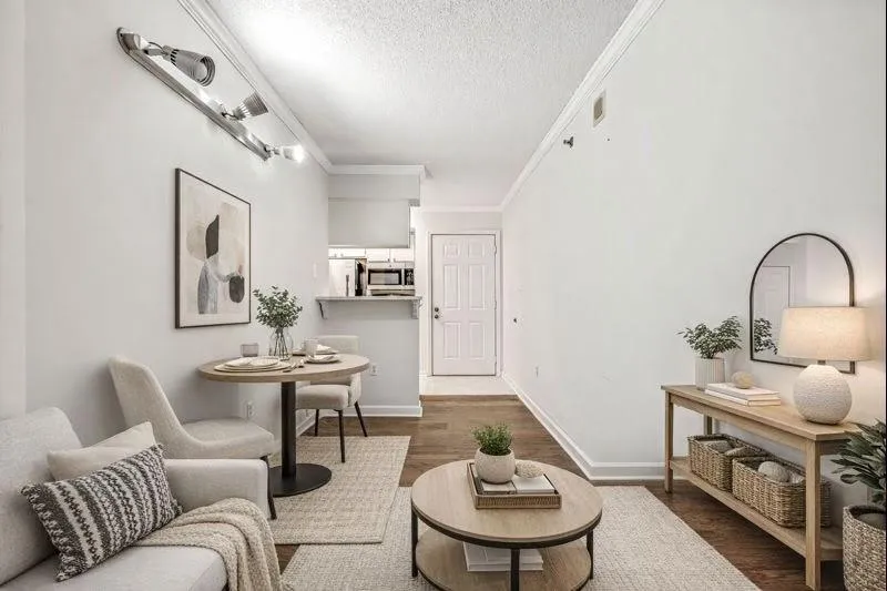 Living room with ornamental molding, a textured ceiling, and dark wood finished floors