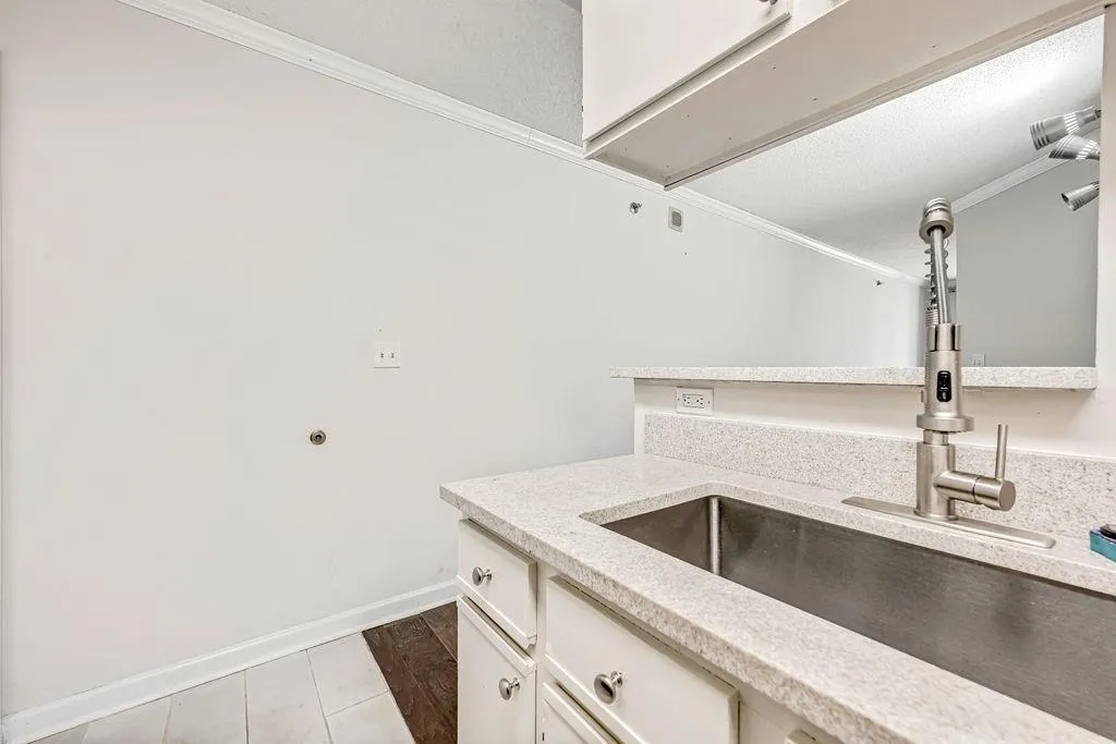 Washroom featuring ornamental molding and attic access
