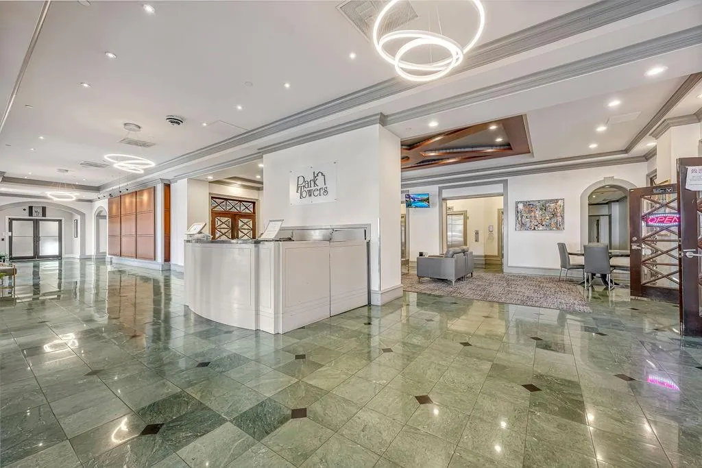 Reception area with arched walkways, ornamental molding, and recessed lighting