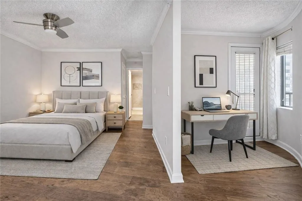 Bedroom with ornamental molding, a textured ceiling, wood finished floors, ceiling fan, and an office area