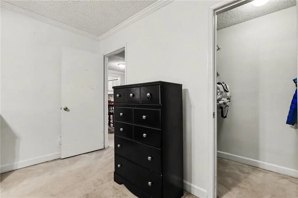 Bedroom featuring a textured ceiling and baseboards