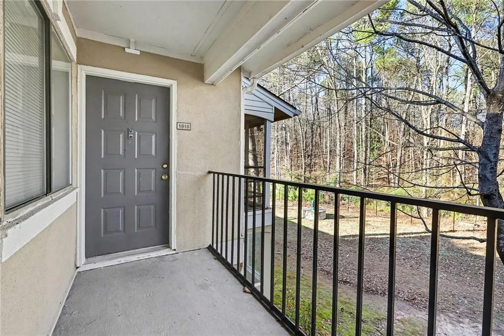 Property entrance featuring stucco siding