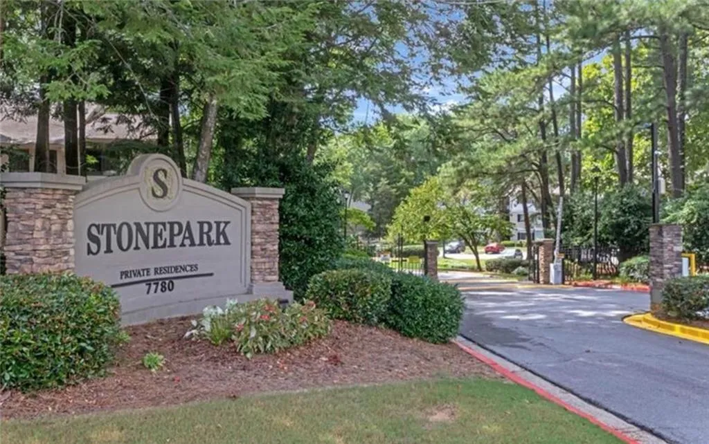 Community sign with view of wooded area