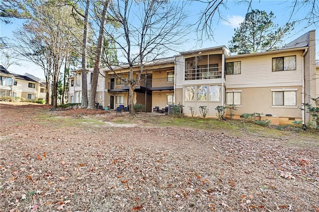 Back of property featuring a patio area and a balcony