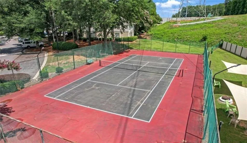 View of tennis court with community basketball court