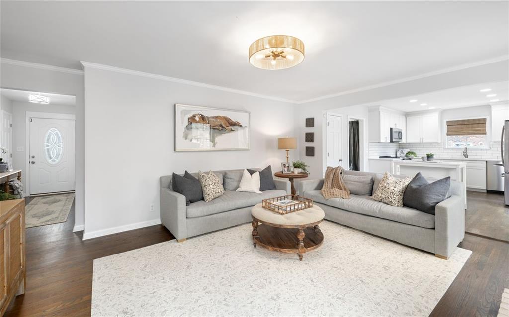 The family room has loads of charm with a stunning wood burning fireplace and French doors leading to the outdoor deck that is perfect for al fresco dining.