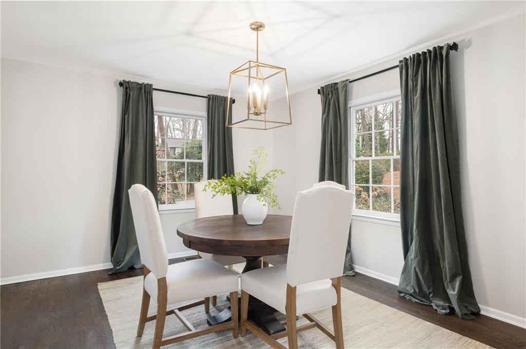 The kitchen is a chef's delight, featuring sleek granite countertops, stainless steel appliances, custom cabinetry, pantry, adjoining dining room and views to the family room.