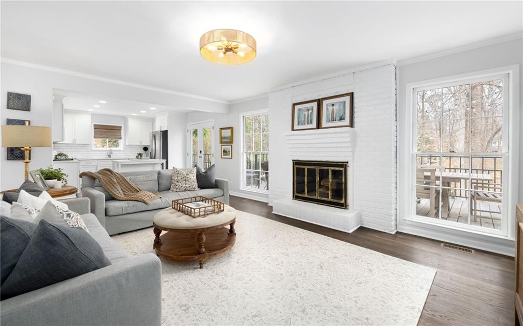 The family room has loads of charm with a stunning wood burning fireplace and French doors leading to the outdoor deck that is perfect for al fresco dining.