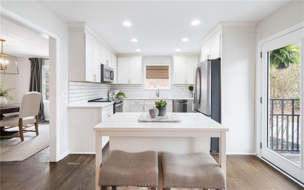 The kitchen is a chef's delight, featuring sleek granite countertops, stainless steel appliances, custom cabinetry, pantry, adjoining dining room and views to the family room.