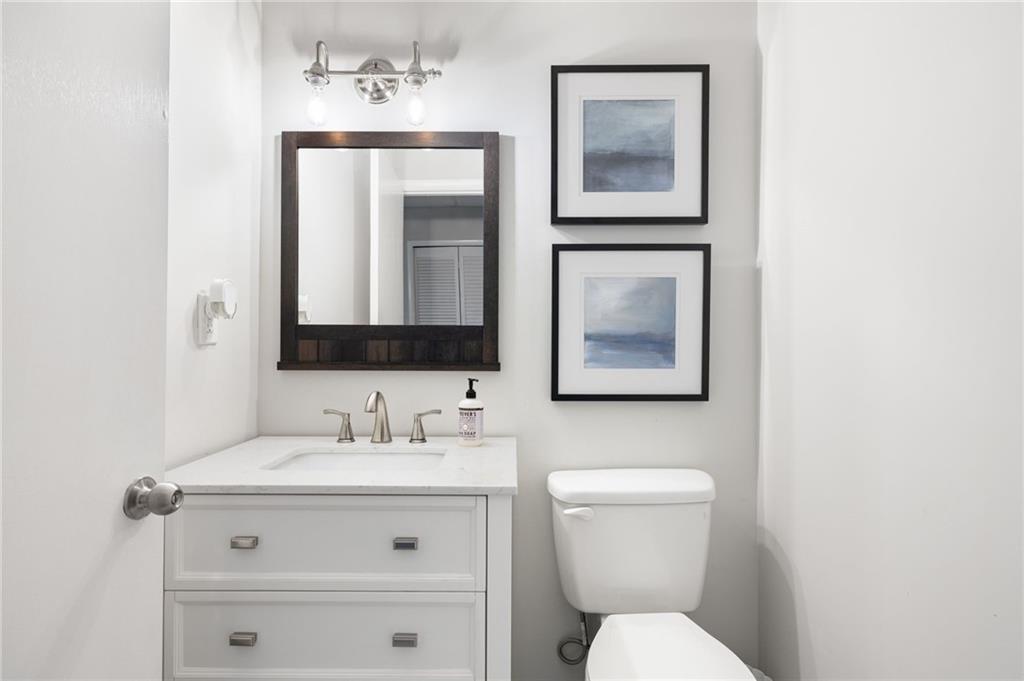 A convenient guest bedroom and half bathroom adds to the functionality of this versatile space.