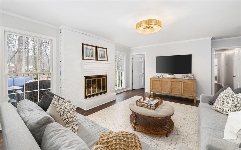 The family room has loads of charm with a stunning wood burning fireplace and French doors leading to the outdoor deck that is perfect for al fresco dining.