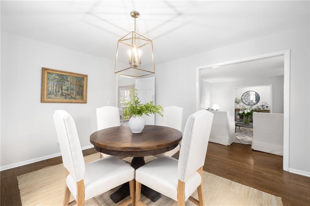 The kitchen is a chef's delight, featuring sleek granite countertops, stainless steel appliances, custom cabinetry, pantry, adjoining dining room and views to the family room.