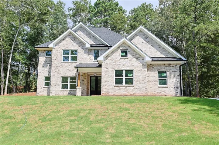Brick exterior with multi-gabled roofline and covered entry