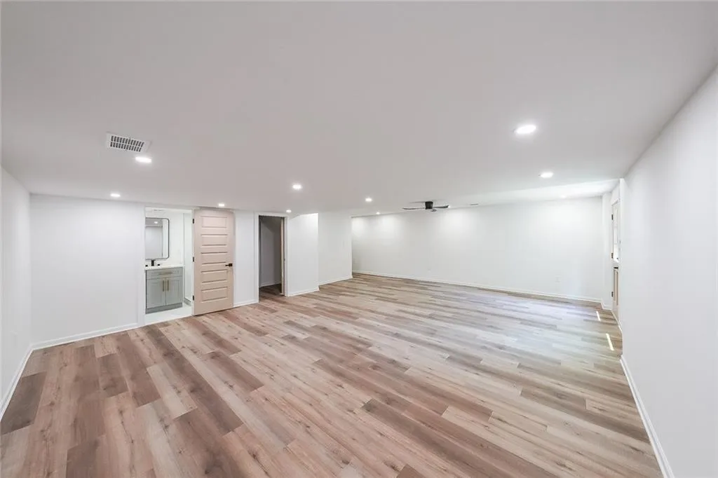 Basement featuring light wood-type flooring