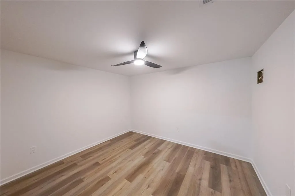 Bedroom with wood-type flooring and ceiling fan