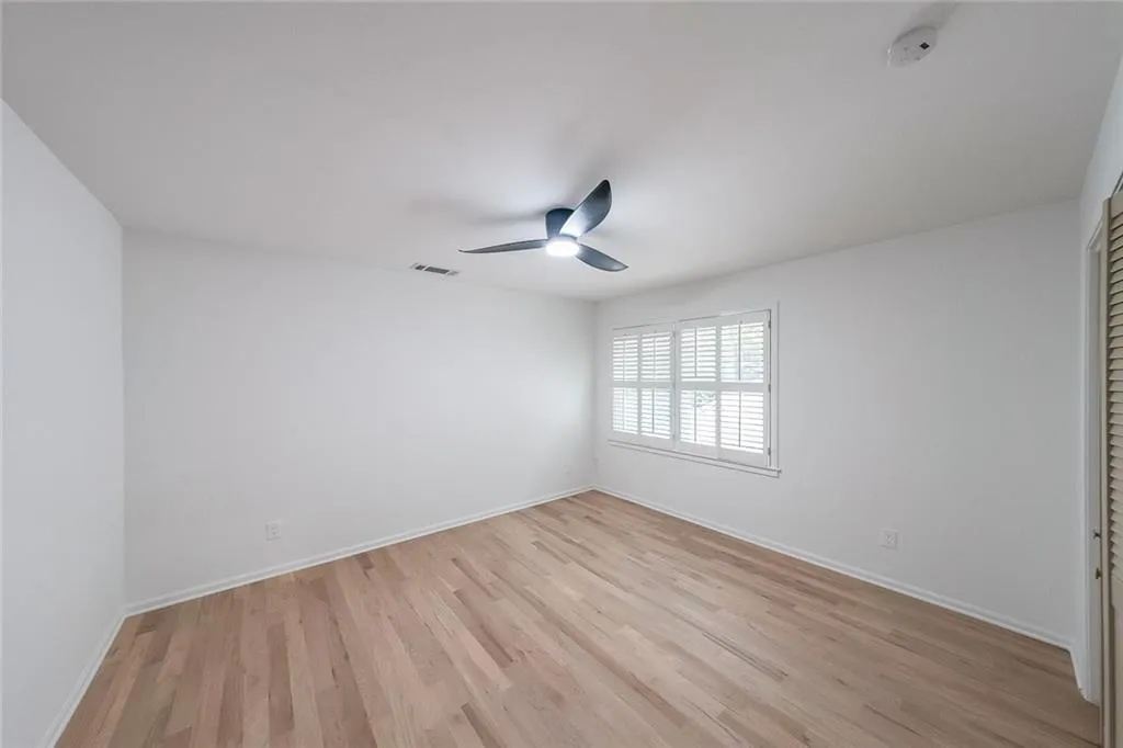 Bedroom  with ceiling fan and light hardwood / wood-style floors