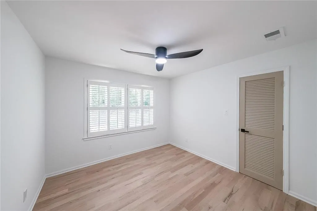 Bedroom with light hardwood / wood-style floors and ceiling fan