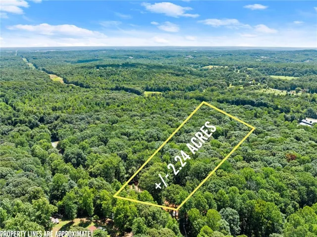 Expansive 12.24-acre parcel surrounded by mature hardwood forest and rolling landscape