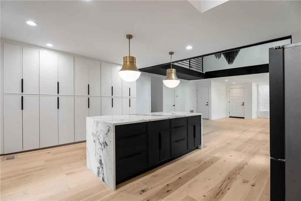 Full wall of pantries and oversized island with quartz countertops. A perfect space for hosting.