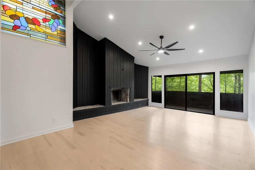 Oversized family room with wood burning fireplace and balcony.