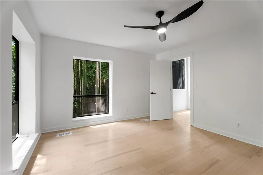 Bedroom 2. Light filled room with large closet and views of greenery and bamboo from the large windows.