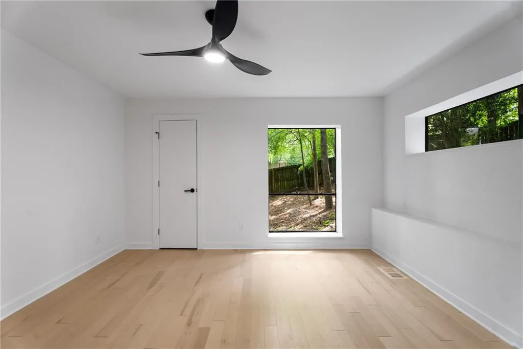 Bedroom 3. Light filled room with large closet and views of greenery and bamboo from the large windows.