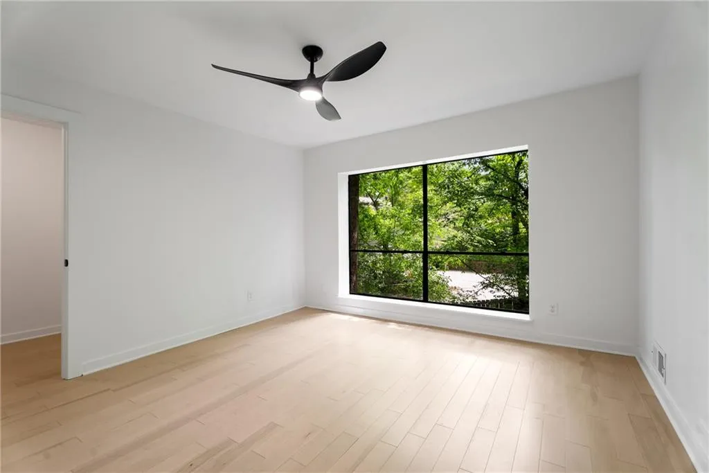 Bedroom 1. Light filled room with large closet and views of greenery and bamboo from the large window.