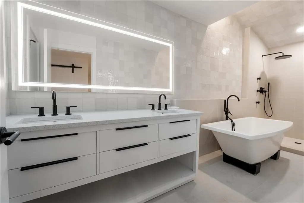 Ensuite primary bathroom with soaker tub, jetted shower, quartz tile and countertops.